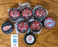 Group shot of all eight pucks, fronts visible