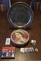 Group shot showing tray, tin, playing cards, mini pitcher, three matchbooks and coin