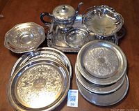 All ten silver-plated pieces grouped on table