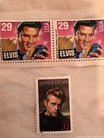 Front view of two 29¢ Elvis Presley stamps and one 32¢ James Dean stamp