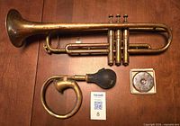 Group view of trumpet, bulb horn with bulb, pitch pipe in box