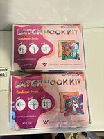 Two sealed latch hook kits in packaging