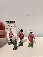 Front view of three Britains soldiers and Kinder Hun figure