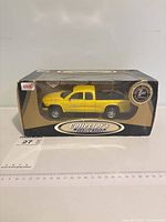 Front view of boxed yellow Dodge Dakota die-cast model