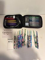 Full lot view showing open case with knitting needles, accessories, and separate crochet hooks