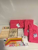 All items grouped: pink linens, stir stick boxes, swizzle sticks, Joie straw pack