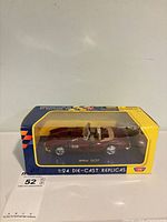 Front view of boxed burgundy BMW 507 die-cast model