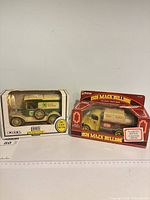 Both boxed coin banks side by side