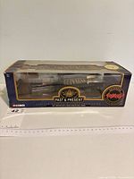 Front angled view of boxed Corgi Guinness Past & Present diecast truck set