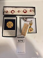 Bracelet, necklace in box, replica pin in separate box