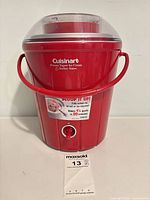 Front view of red Cuisinart ice cream maker with handle and power dial