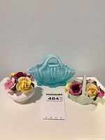 Front view of Davidson basket flanked by two china flower bouquets