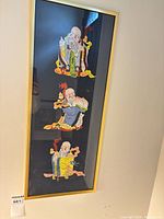 Full view of framed artwork showing three paper cuts