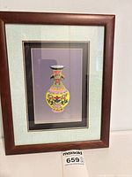Full view of framed embroidery artwork