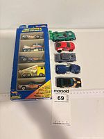 Boxed Team Racers II set beside five loose cars