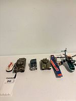 Line-up of six die-cast military toys on surface