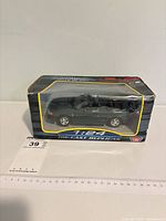 Front and side view of boxed 1:24 green convertible model car