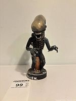 Front view of NECA Alien figure on base