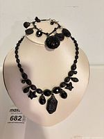 Necklace on bust with bracelet displayed, showing overall style