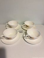 Four teacups and four saucers arranged together