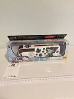 Front view of boxed diecast bus displaying Toronto Maple Leafs graphics and scale information