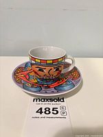 cup on saucer front view displaying graphics