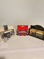 Three boxed die-cast vehicles side by side
