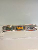 Overview of three boxed Dinky Collection vehicles
