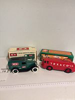 Both coin banks with their original boxes side by side