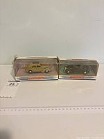 Two boxed Dinky Ford V8 Pilot models side by side
