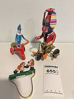 Group shot of all three tin toys and key