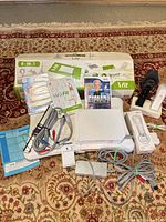 Overview of Wii console, balance board, games, cables, accessory kit