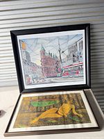 Both framed prints standing upright