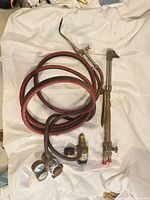 Coiled red/black hose with regulators and one torch attachment