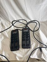 Two Husky 10-outlet power strips with cords displayed side by side