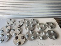 Group shot of all 16 clutch ball retainers on table