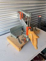 Overall view of Craftsman miter saw set on wood platform