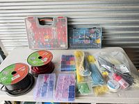 Entire lot overview showing wire spools, organizers, cable ties and accessories