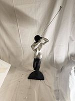 Front view of golfer statue showing pose and finishes