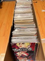 Top view of long box filled with bagged comics, leading issue America