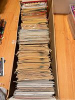 Top view of long box filled with stacked comic books