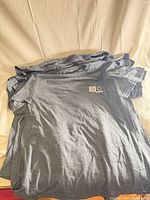 Stack of grey Gildan DryBlend T-shirts showing overall appearance