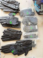 Overview of all ten glove pairs, some bagged, some loose with tags