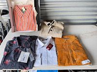 Five clothing items laid out on table