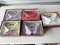 Five boxed dress shirts on table