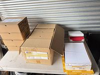 Overview of all envelope cartons on table