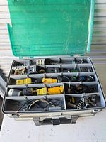 Overall view of open organizer showing compartments filled with electrical parts