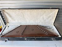 Santoor inside open plush-lined case