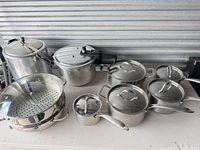 Full grouping of stainless cookware including pressure cookers, steamer set, saucepans and stockpot