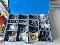 Top view of open organizer showing multiple compartments filled with cabinet lock parts